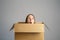 Smart idea.. Teenager student girl sitting inside cardboard box  looking up