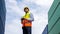 Smart industrial foreman standing on containers stack controlling at warehouse