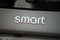 Smart logo of grey rear car parked in the street