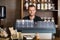 Smart Male Bartender At Counter In Cafe