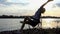 Smart Man Does a Relaxing Exercise in a Folding Chair at Sunset in Slo-Mo