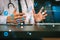 Smart medical doctor working with smart phone and digital tablet computer and stethoscope on wood desk in modern office