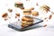 Smart phone and burgers, slices of pizza and other food ingredients from fast food flying from the screen