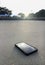 Smart phone lying on a sand of the clear beach with as light of sunset, it\'s mean stop social for relax