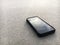 Smart phone lying on a sand of the clear beach, it\'s mean stop social for relax