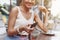 Smart phone online shopping in woman hand. Desk with coffee in background. Hands holding credit card and using mobile smart phone