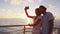 Smart phone selfie - Romantic couple on small cruise ship sunset over the ocean