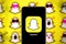 Smart phone with the snapchat logo, which is a messaging application for smartphones
