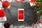 Smart phone surrounded with Christmas decorations. Top view scene