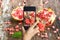 Smart phone take photos of pomegranate on wooden background