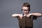 Smart pupil in glasses with textbook in hands