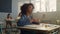 Smart pupil studying science at elementary school. Girl raising hand at lesson