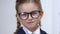 Smart schoolgirl adjusting eyeglasses closeup, elementary school pupil education