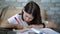 Smart schoolgirl studying at home during coronavirus pandemic