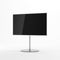 Smart TV Mockup on metal stand in gray studio