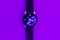 Smart watch on the glowing neon purple,veri peri color background with empty space for your text.Closeup,copy space