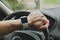 Smart watch on the hand of car driver
