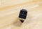 Smart watch on wooden background.