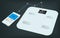 Smart weight scale and a smartphone with weight information on it`s display. Getting information of weight using mobile app.