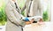 Smart woman stands, holds airplane model with businessman at background in meeting room, selective focus at airplane model.