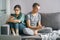 Smartphone addicted couple scrolling through social networks using phones sitting on the couch at home