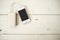 Smartphone is charged from the portable charging device for shabby the wooden table