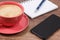 Smartphone, coffee with milk and notepad for notes. Work or relaxation with mobile phone