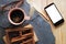 Smartphone,coffee mug and spices on granite.