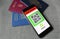 Smartphone with digital health passport app with three passports for travel covid-19 pandemic