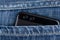 Smartphone with dual camera in back pocket of jeans