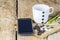 Smartphone, earphone,coffee beans and coffee mug on wooden table