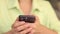 Smartphone in female hands. Close-up of a phone