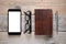 Smartphone, glasses, diary and pen on wooden table