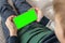 Smartphone with a green screen in hand child . Phone a for keying is holding kid