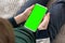 Smartphone with a green screen in hand child . Phone a for keying is holding kid close up top view
