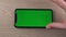 Smartphone with green screen mockup, zoom, hand close up, mobile phone user