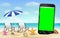 Smartphone green screen on sea sand beach