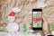 Smartphone on hand with `SALE` on screen, with crumpled paper cut snowman in winter, Christmas shopping sale, online store sale