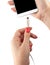 Smartphone in the hand of a woman. Connect the USB cable charger