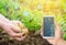 Smartphone in the hands of a farmer. Smart agriculture. Automation and crop quality improvement. High technology, innovation.