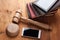 Smartphone, the judge`s gavel on wooden background.