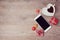 Smartphone mock up flat lay for Valentine\'s day with coffee cup and chocolate. View from above