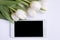 Smartphone mock up and white flowers. Mockup for Floral business. Spring time