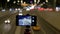 The smartphone is mounted on a tripod. They shoot on video, traffic of cars, against a background of beautiful lights