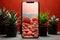 Smartphone with natural wallpaper on the table with a potted aloe houseplant