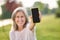 Smartphone in outstretched hand of smiling woman