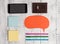 Smartphone phone pens ballpoints blank colored speech bubble sticky notes leather wallet lying wooden rustic vintage