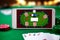Smartphone with poket table on screen, playing cards and chip cards on poker table