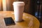 A smartphone rests on a table in a cafe,
