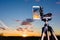 Smartphone on tripod capturing image of sundown in vertical mode